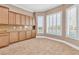 Bright breakfast nook featuring backyard views through plantation shutters and custom wood cabinets at 11730 Stonewall Springs Ave, Las Vegas, NV 89138