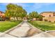 Community park featuring a paved walkway and lush landscaping at 11730 Stonewall Springs Ave, Las Vegas, NV 89138