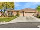 Beautiful single-story home featuring a spacious driveway and a two-car garage at 11730 Stonewall Springs Ave, Las Vegas, NV 89138