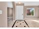 Inviting foyer featuring tile flooring with black accents and a view into the living spaces at 11730 Stonewall Springs Ave, Las Vegas, NV 89138