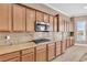 Modern kitchen featuring granite counters, stainless steel appliances and a gas cooktop stove at 11730 Stonewall Springs Ave, Las Vegas, NV 89138