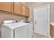 Functional laundry room with ample cabinets for storage and modern washer and dryer at 11730 Stonewall Springs Ave, Las Vegas, NV 89138