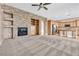 Open concept living room featuring a stone fireplace, built-ins, and archway to the kitchen at 11730 Stonewall Springs Ave, Las Vegas, NV 89138
