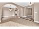 Open living area with tile floors, arched entrances, and neutral color scheme at 11730 Stonewall Springs Ave, Las Vegas, NV 89138