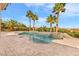 Sparkling backyard pool and spa surrounded by palm trees and lush landscaping at 11730 Stonewall Springs Ave, Las Vegas, NV 89138