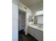 Updated bathroom with a vanity, mirror, and toilet, plus dark, modern wood-look flooring at 1308 Dusty Creek St, Las Vegas, NV 89128