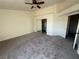 Neutral bedroom with carpet, ceiling fan, closet and door leading to a connected bathroom at 1308 Dusty Creek St, Las Vegas, NV 89128