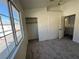 A bedroom with a bright window, a double-door closet, and neutral carpeting at 1308 Dusty Creek St, Las Vegas, NV 89128