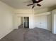 Bedroom featuring mirrored closet doors, a ceiling fan, neutral carpet, and a double-door closet at 1308 Dusty Creek St, Las Vegas, NV 89128