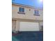 Two-story home featuring an attached two-car garage with a white door at 1308 Dusty Creek St, Las Vegas, NV 89128