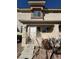 A tan two-story townhouse featuring a small porch area with stairs leading to the front door at 1308 Dusty Creek St, Las Vegas, NV 89128