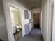 Hallway with gray carpeted floors leading to a bathroom with shower and storage cabinets at 1308 Dusty Creek St, Las Vegas, NV 89128