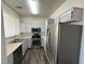 Modern kitchen featuring stainless steel appliances and light gray cabinets with wood-look flooring at 1308 Dusty Creek St, Las Vegas, NV 89128