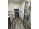 Bright kitchen with stainless steel appliances, gray cabinets, and modern flooring at 1308 Dusty Creek St, Las Vegas, NV 89128