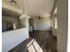 Open floor plan with wood-look floors, ceiling fan, and a large bright window at 1308 Dusty Creek St, Las Vegas, NV 89128