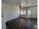 Living area featuring wood-look floors, ceiling fan, and good natural light from windows at 1308 Dusty Creek St, Las Vegas, NV 89128