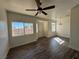 Bright living area with wood-look floors and a ceiling fan in an open-concept space at 1308 Dusty Creek St, Las Vegas, NV 89128