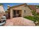Exterior of home featuring a large brick patio and well-maintained lawn at 1375 Gran Vista Ave, Henderson, NV 89012