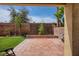 Cozy backyard featuring a brick-paved patio, well-maintained lawn, and lush landscaping with trees, offering a private outdoor retreat at 1375 Gran Vista Ave, Henderson, NV 89012