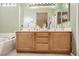 Bathroom with double sinks, a large mirror, a bathtub, and neutral-toned walls at 1375 Gran Vista Ave, Henderson, NV 89012