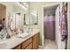 Bright bathroom with a dual sink vanity, tub/shower combo, and contemporary finishes at 1375 Gran Vista Ave, Henderson, NV 89012