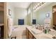 This bathroom boasts double sinks, a tub, and tasteful decor, perfect for a relaxing space at 1375 Gran Vista Ave, Henderson, NV 89012