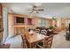 Open concept dining and living area with neutral colors, ceiling fans and tile flooring at 1375 Gran Vista Ave, Henderson, NV 89012