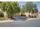 Beautiful home exterior featuring a two-car garage, lush landscaping with mature trees, and a well-maintained driveway at 1375 Gran Vista Ave, Henderson, NV 89012
