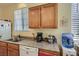 Kitchen featuring stainless steel sink, light wood cabinets, granite countertops, and bright lighting at 1375 Gran Vista Ave, Henderson, NV 89012