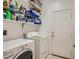 Functional laundry room featuring a washer, dryer, and shelving at 1375 Gran Vista Ave, Henderson, NV 89012