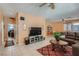 Comfortable living room with tile flooring, neutral paint, large windows, and a cozy sectional sofa, ideal for relaxation and entertaining at 1375 Gran Vista Ave, Henderson, NV 89012