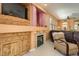 Cozy living space featuring a fireplace with built-in cabinetry, lots of natural light, and comfortable seating at 1375 Gran Vista Ave, Henderson, NV 89012