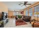 Spacious living room featuring tile flooring, natural light from large windows, and a ceiling fan for added comfort at 1375 Gran Vista Ave, Henderson, NV 89012
