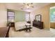 Relaxing main bedroom features neutral tones, tile floors, a ceiling fan, and an ensuite bathroom at 1375 Gran Vista Ave, Henderson, NV 89012