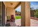 A covered patio area that includes patio furniture and provides views of the backyard and lush landscaping at 1375 Gran Vista Ave, Henderson, NV 89012