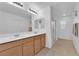 Bathroom with double sinks, modern fixtures, and a glass-enclosed shower stall at 1909 Pinsky Ln, North Las Vegas, NV 89032