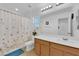 Bright bathroom featuring a shower-tub combo, vanity with sink, and neutral decor at 1909 Pinsky Ln, North Las Vegas, NV 89032