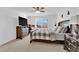 Spacious bedroom features a dresser, dark wood bed frame, ceiling fan, and plenty of natural light at 1909 Pinsky Ln, North Las Vegas, NV 89032