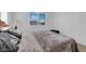 Well-lit bedroom featuring a comfortable bed, a window, and a closet with sliding doors at 1909 Pinsky Ln, North Las Vegas, NV 89032