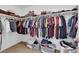 Walk-in closet featuring an extensive wardrobe of neatly arranged clothing on shelves and hangers at 1909 Pinsky Ln, North Las Vegas, NV 89032
