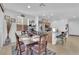 Cozy dining area with a table set for a meal, adjacent to the open kitchen and living space at 1909 Pinsky Ln, North Las Vegas, NV 89032