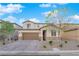 Charming two-story home with stone accents, a well-maintained yard, and a paved driveway at 1909 Pinsky Ln, North Las Vegas, NV 89032
