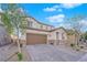 Charming two-story home with stone accents, a well-maintained yard, and a paved driveway at 1909 Pinsky Ln, North Las Vegas, NV 89032