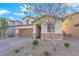 Charming two-story home with stone accents, a well-maintained yard, and a paved driveway at 1909 Pinsky Ln, North Las Vegas, NV 89032