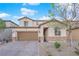Charming two-story home with stone accents, a well-maintained yard, and a paved driveway at 1909 Pinsky Ln, North Las Vegas, NV 89032