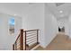 Upstairs hallway with stairs and a window for natural light at 1909 Pinsky Ln, North Las Vegas, NV 89032