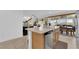 Open concept kitchen with granite countertops and stainless steel appliances, and view of Gathering room at 1909 Pinsky Ln, North Las Vegas, NV 89032