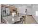Modern kitchen island with seating, stainless steel appliances, and open design to the dining area at 1909 Pinsky Ln, North Las Vegas, NV 89032