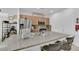 Open kitchen with stainless steel appliances, granite countertops, and island with barstool seating at 1909 Pinsky Ln, North Las Vegas, NV 89032