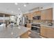 Modern kitchen with stainless steel appliances, granite countertops, and ample storage at 1909 Pinsky Ln, North Las Vegas, NV 89032